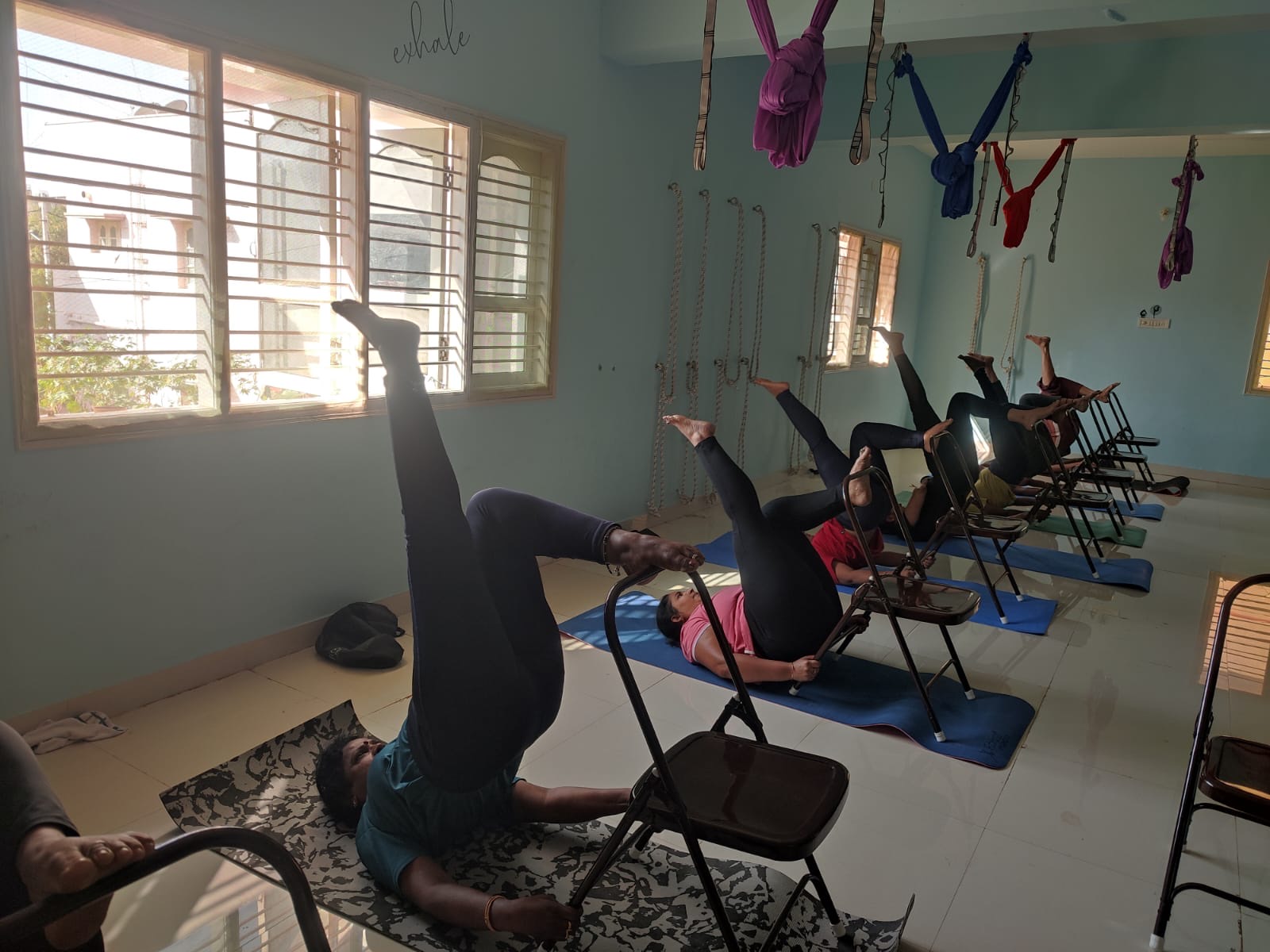 Students resting their legs on folding chairs during class